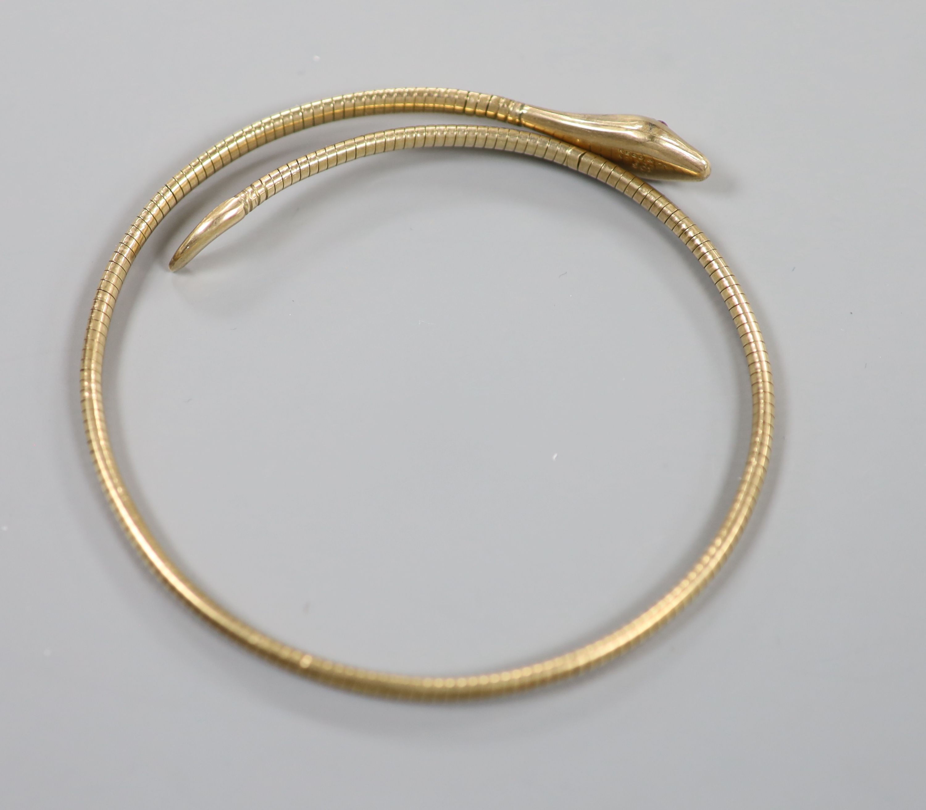 An early to mid 20th century 9ct coiled serpent bracelet, with gem set eyes (one missing), gross 15.4 grams.